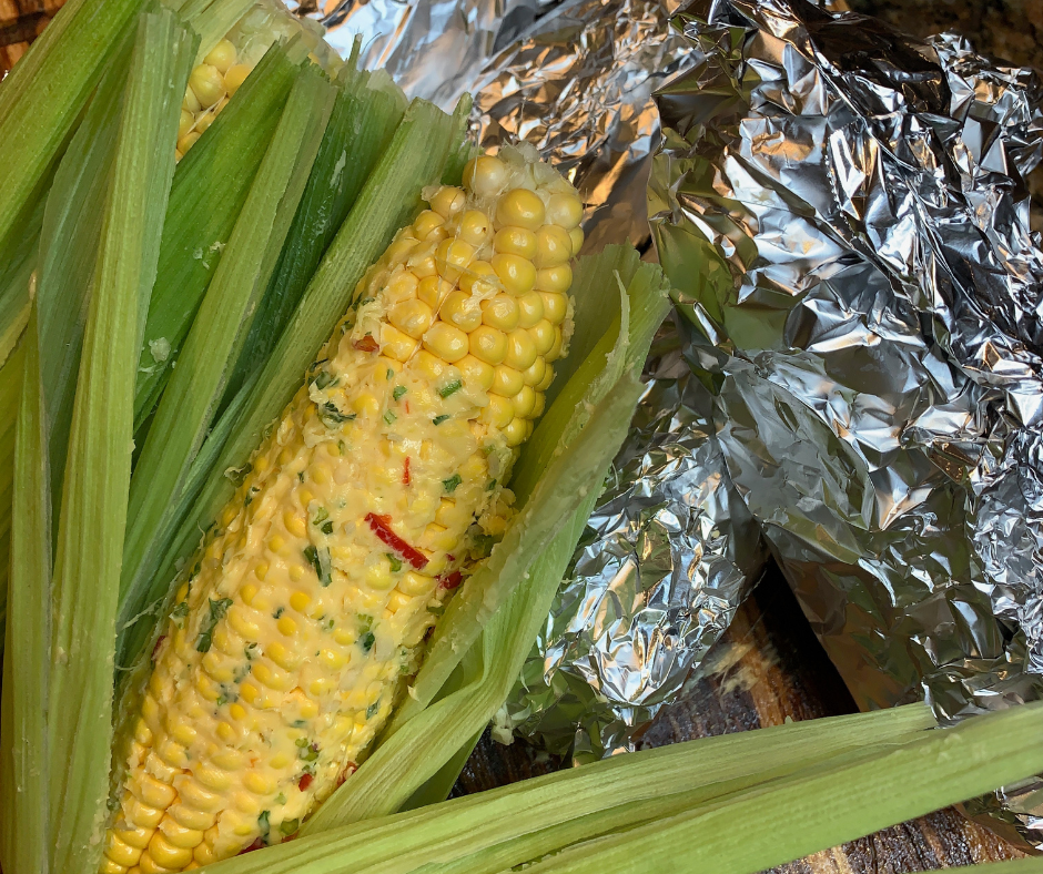 Char-grilled corn on the cob in foil